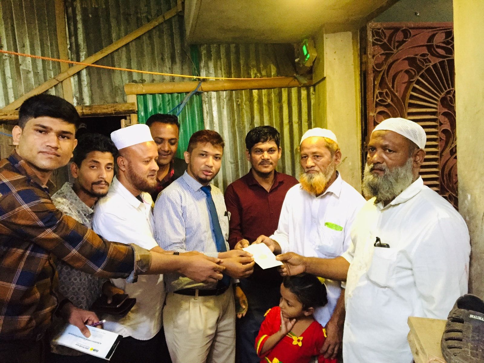 Hon'ble MD Ershad Ullah Khan handing over the donation check to the nominee of late Nurul Haquue
